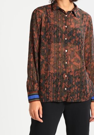 Hemd mit Knopfverschluss aus einem transparenten, dunklen Stoff mit Floralprint. Verfügt über horizontale Streifen in Blau und Rot an den Bündchen.