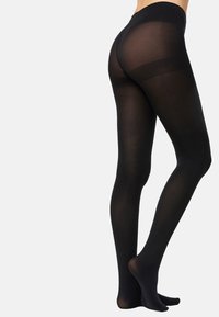 Medias opacas negras con acabado mate, con cintura alta y diseño sin costuras, que llegan hasta el tobillo con una textura suave.