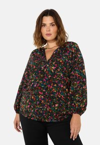 Blusa nera floreale con maniche lunghe a palloncino, scollatura a V e pattern floreale multicolore. Tessuto morbido con sottili dettagli di texture.