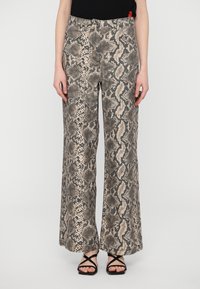 Pantaloni a gamba larga con stampa serpente in toni beige e grigi, dotati di una finitura testurizzata e design a cinque tasche, abbinati a sandali neri con cinturini.