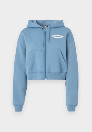 Κοντοκόψε μπλε φούτερ σε μαλακό ύφασμα με μπροστινό φερμουάρ, δύο μπροστινές τσέπες και λευκό κείμενο "New Balance Athletics" στο στήθος.