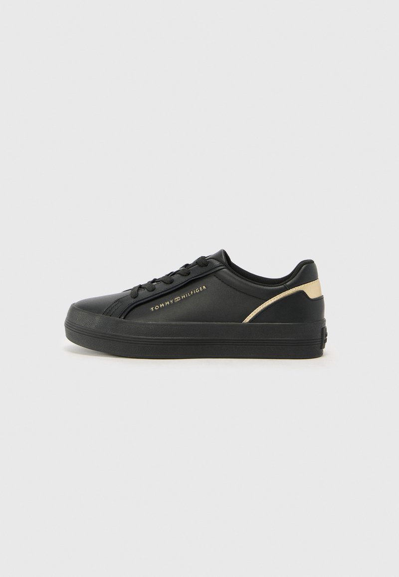 Black synthetic sneakers with a rounded toe, black rubber sole, gold accent near the heel, and logo on the side. Lace-up design.