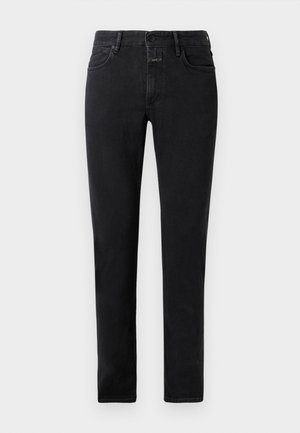 Mustad slim-fit teksad viie taskuga, nööbiga ja vöökandmisse, laotatuna heledale taustale.