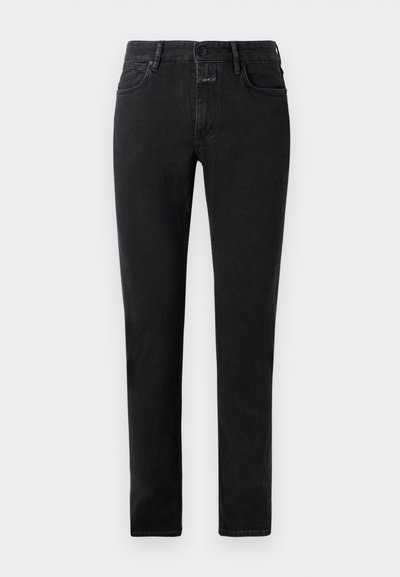 Black slim-fit jeans with five pockets, button closure, and belt loops laid flat on a light background.