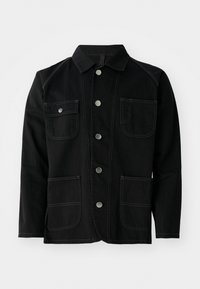 Black cotton jacket featuring a classic collar, five front snap buttons, two large patch pockets, contrasting stitching, and long sleeves.