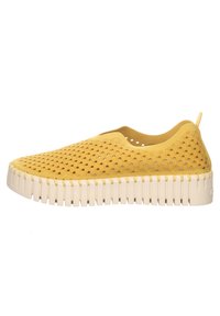 Scarpa gialla slip-on con una tomaia testurizzata e perforata e una suola bianca a coste a contrasto. Leggera e progettata per la traspirabilità.