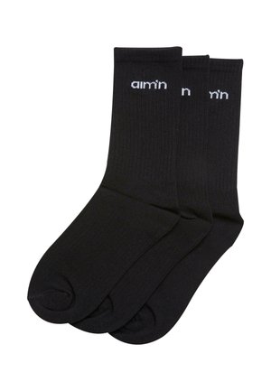 Čierne bavlnené ponožky s rebrovanou textúrou, s potlačeným bielym logom "aim’n" na vrchu. Tri páry naskladané spolu.