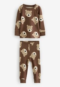 Pametni set pidžame od pamuka u smešnoj boji sa dugim rukavima i dugim pantalonama. Oba dela imaju ponavljajući print medveda u bež boji sa crnim detaljima.