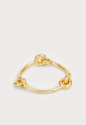 Armbånd i gulltone-metall med sirkulære lenker og en glatt, polert finish. Designet inkluderer sammenflettede knuter for ekstra detaljer.