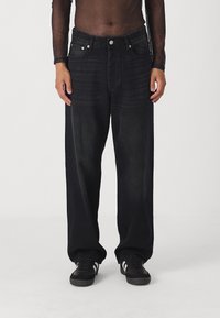 Black wide-leg jeans made of denim, featuring front pockets, a button closure, and subtle vertical texture along the fabric.