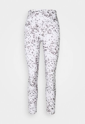 Leggings made of stretchy fabric, featuring a white base with scattered brown and black speckled patterns. Mid-rise waist, slim fit.