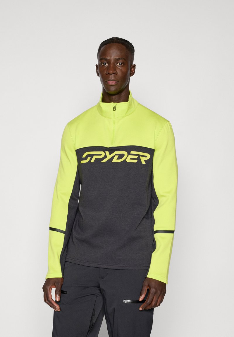 Halv-innsats pullover i lys gul og mørkegrå, med "SPYDER"-logo, glatt tekstur og kontrastfargede svarte detaljer på ermene.
