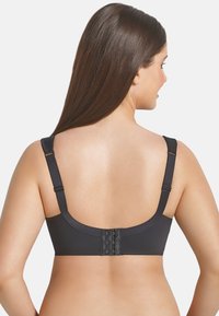 Black bra featuring adjustable straps, a smooth finish, and a secure three-hook back closure for support and comfort.