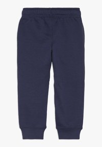 Marina blå mjukisbyxor i en mjuk bomullsblandning, med resårmidja och smalnande ben med ribbade muddar för en åtsittande look.