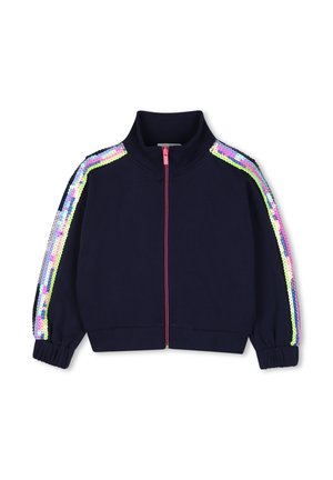 Marineblauwe jas met roze rits en meerkleurige paillettenstrepen langs beide mouwen, met hoge kraag en elastische manchetten.