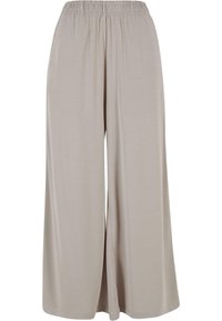 Pantalon beige clair à jambes larges en tissu doux. Dispose d'une ceinture élastique et d'une texture lisse, arrivant sous la cheville.