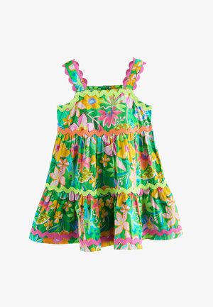 Sleeveless green dress with pink, yellow, and orange floral patterns and wavy trim along straps, bodice, and hem.