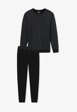 Haut noir à manches longues avec un motif texturé et pantalon noir uni. Les deux articles présentent des poignets côtelés et un design décontracté.