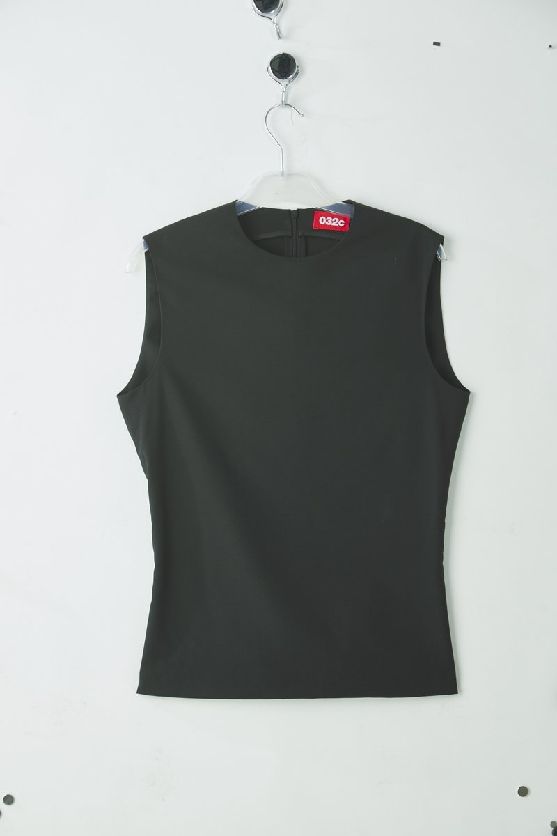 Black sleeveless top with a high neckline, made of smooth fabric, featuring a back zipper closure and a tag displaying "032C."