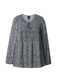 Nais long-sleeve blouse na pambabae na may itim at puting abstract na pattern, bilog na neckline, at detalye ng pagkakabit sa harapan.