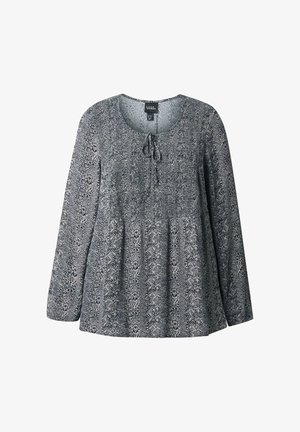 Blusa da donna a maniche lunghe con motivo astratto in bianco e nero, scollatura rotonda e dettaglio con nodo frontale.
