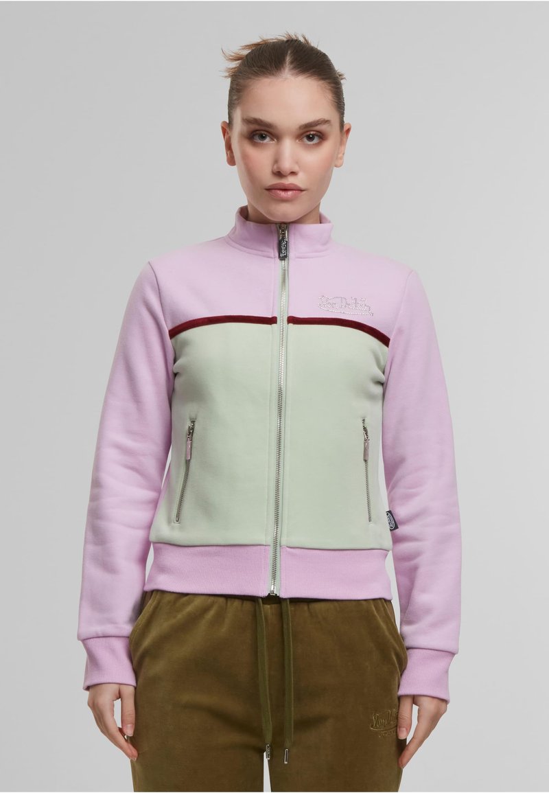 Veste zippée en rose clair et vert menthe, avec une stripe bordeaux et deux poches latérales zippées. Tissu doux avec un ourlet côtelé.