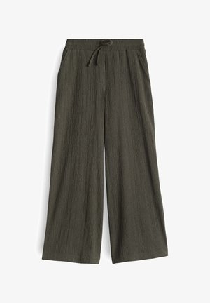 Weite Hosen in dunklem Olivgrün, aus strukturiertem Stoff gefertigt. Mit einem elastischen Bund und einem Kordelzug für eine verstellbare Passform.