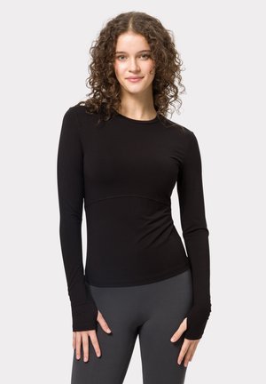 Zwarte langefse top in een aansluitend ontwerp, gemaakt van rekbaar materiaal, met duimopeningen bij de manchetten en een subtiele naad over de taille.