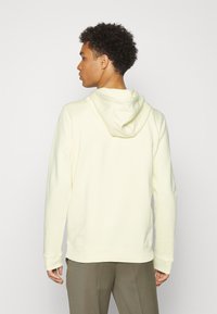 HUGO DARATSCHI - Sweatshirt com capuz - light pastel yellow