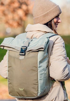 Roll-top backpack in light blue and olive green nylon. Features a buckle closure, side pocket, and logo at the bottom. Smooth texture.