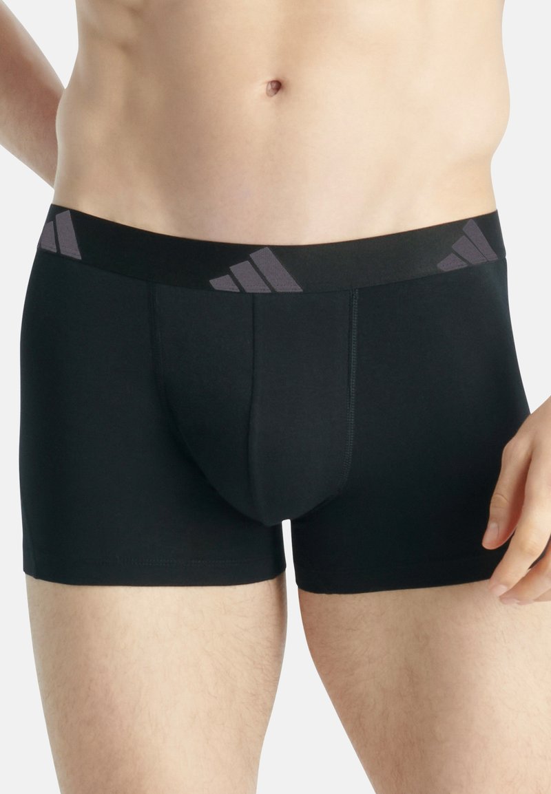 Zwarte boxer shorts met een zachte, elastische tailleband met drie grijze strepen. Gladde textuur, aansluitende pasvorm en geen extra patronen.