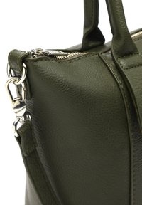 Maslinasto zelena kožna torba s teksturiranim finišom, metalnim detaljima i zatvaranjem na patentni zatvarač. Ima dvostruke ručke i podesivu naramenicu.