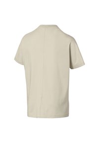 Béžové bavlněné tričko s volným střihem, krátkými rukávy a kulatým výstřihem. Na zadní straně je středový šev. Měkká textura.