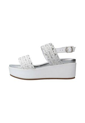 Sandali platform bianchi con cinturini intrecciati e fibbia regolabile alla caviglia. Accenti argentati sulla soletta, suola testurizzata e finitura liscia.