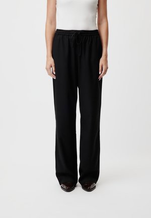 RABEA PANTS - Tracksuit bottoms - schwarz