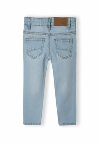 Svetlo modri jeans s fit obliko, ki imajo dve zadnji žepki z diskretnim šivom in rjav kožni zaklop na pasu.