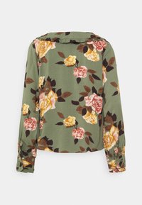 Camicetta floreale a maniche lunghe in tessuto verde, con rose multicolori in giallo, rosa e marrone, un colletto arricciato e polsini con bottoni.