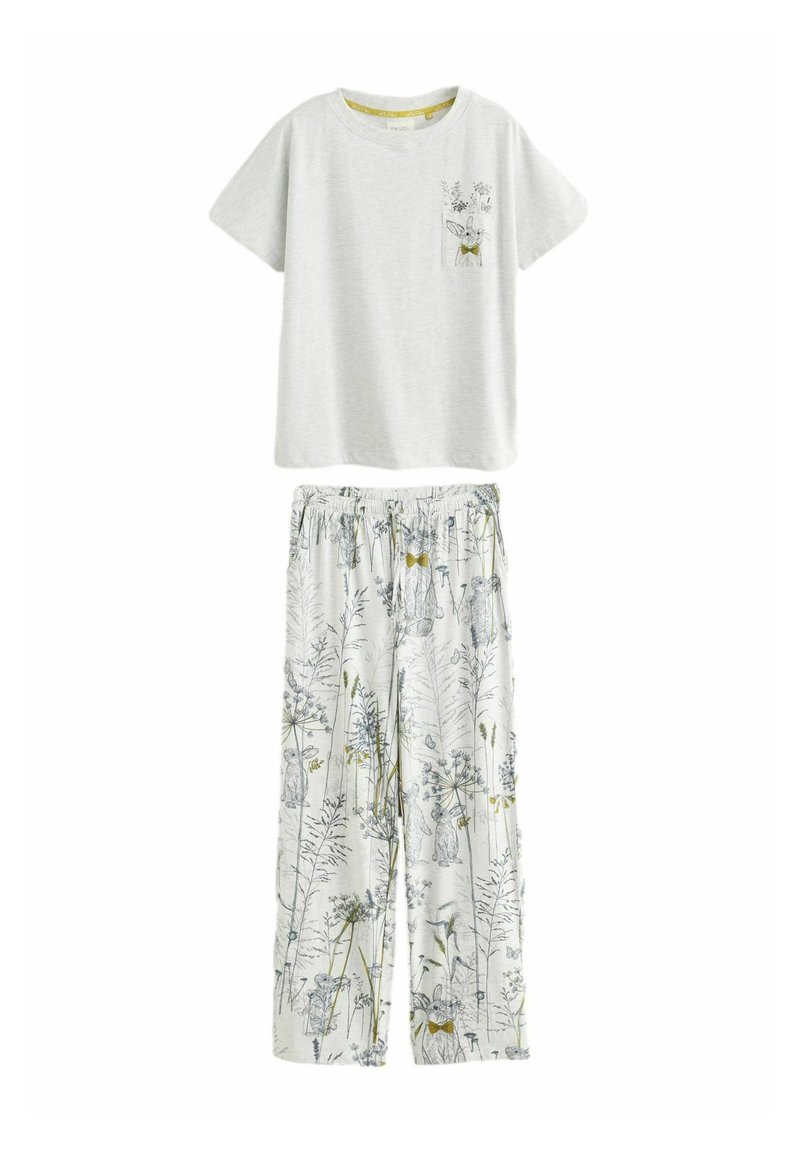 Camiseta gris de manga corta con un bolsillo y un diseño de conejo floral, combinada con pantalones blancos de corte holgado con estampados botánicos.