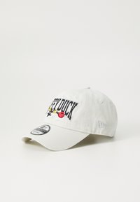 White cotton cap with embroidered "LEFT DUCK," yellow flowers, and red accents. Curved visor and adjustable strap at the back.