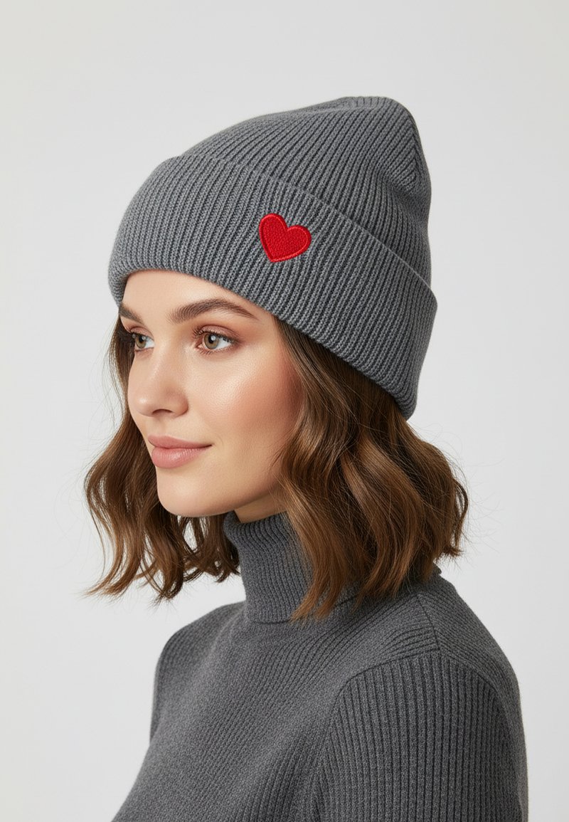 Gray ribbed knit beanie featuring a small red heart embroidery on the front, paired with a matching gray turtleneck sweater.