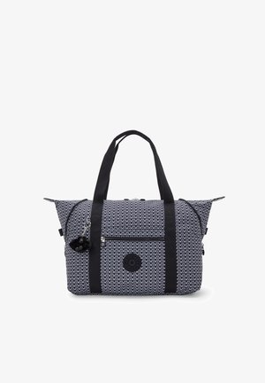 Navy and white geometric patterned fabric bag with black dual straps, top zip closure, front pocket, and detachable pom-pom accent.