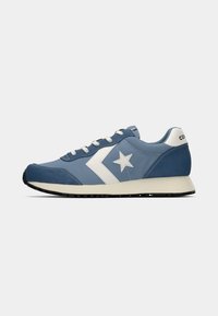 Blue sneaker featuring a smooth leather and suede upper, white star accent, round toe, and contrasting black sole. Neutral lace closure.