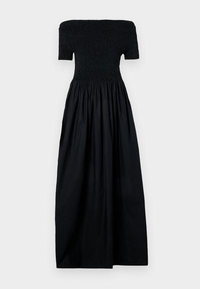 Juoda su peties nuleista suknele su raukiniuotu liemeniu, trumpomis rankovėmis ir puria, susiraukšlėjusia sijonu. Pagaminta iš lengvos medžiagos, su glotnia tekstūra.