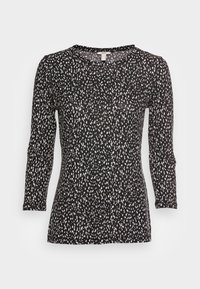 Černý top s dlouhým rukávem s bílým tečkovaným vzorem, kulatým výstřihem a slim fit střihem. Vyrobeno z měkké, lehké tkaniny.