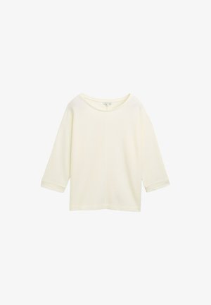 Haut léger en ivoire, ample, avec des manches trois-quarts, en tissu texturé, col rond et ourlet droit.