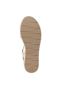 Beige podešev sandálů s strukturovaným gripem, který obsahuje horizontální drážky a mírnou klenbu. Branding je viditelný na mezipodešvi.