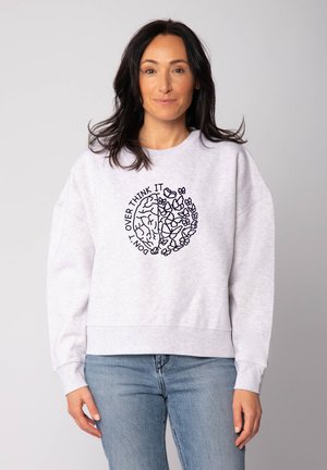 Sweatshirt en coton gris avec des poignets et un ourlet côtelés, arborant un design graphique noir d'un cerveau et de fleurs avec le texte "NE PAS SURANALYSER."