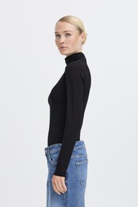 Black turtleneck bodysuit made of stretchy fabric, fitted design, long sleeves, paired with high-waisted light blue denim jeans.