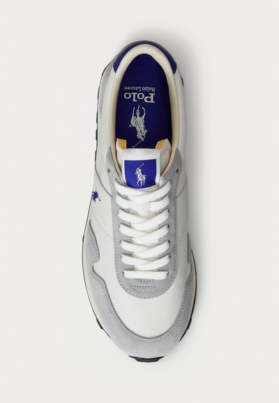 White and grey men's sneaker with white laces, navy blue inner sole and logo featuring a polo player on horseback.