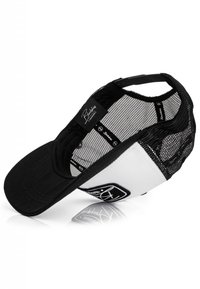Black and white cap with a curved bill, mesh backing, and a logo patch on the front panel. Adjustable snapback closure.